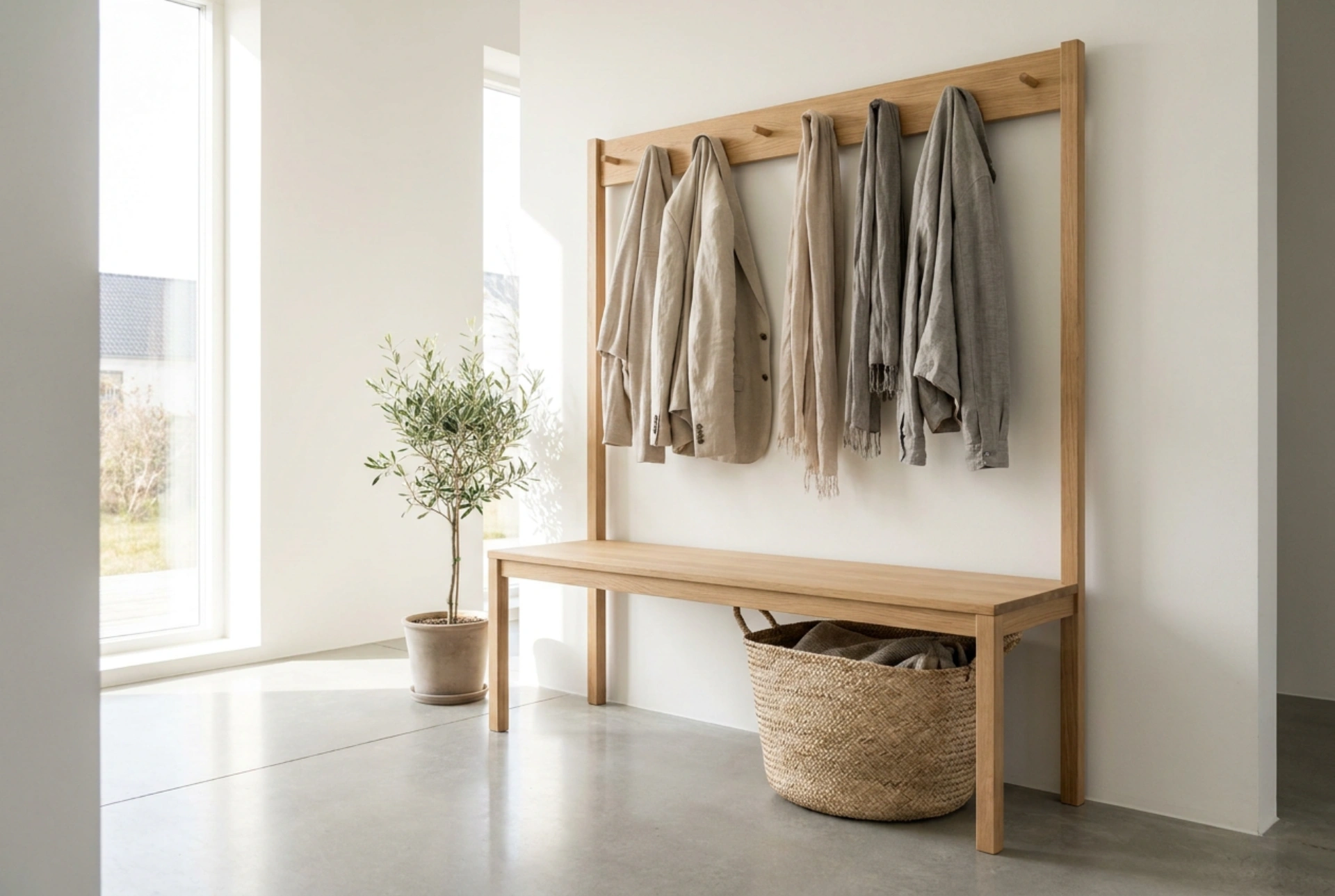 An entryway bench with a coat rack organises morning departures